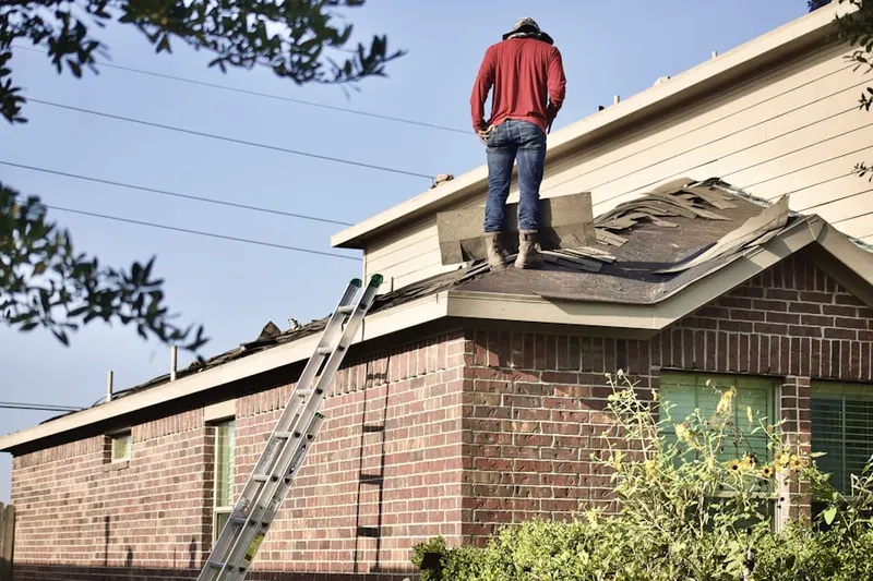 Professional roofer working on a residential roof in Whitehall Beach